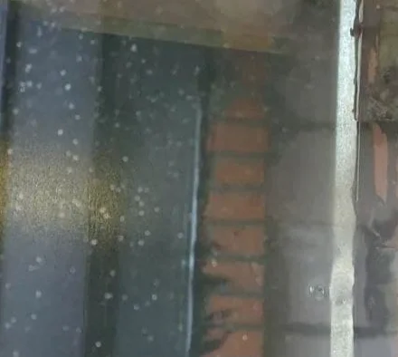 Removal of weld and grind spatter from construction glass